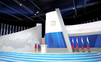 Empty stage with Russian flags and a podium in a modern setting