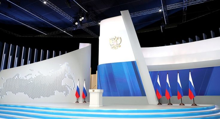 Empty stage with Russian flags and a podium in a modern setting